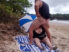 Fat nudist sucks publicly on the beach..